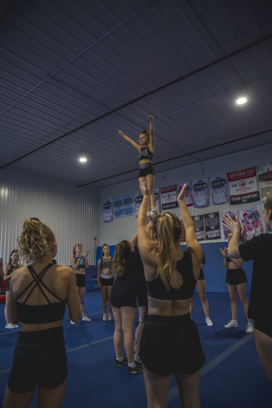 CheerCore Jags athlete being coached through a stunt